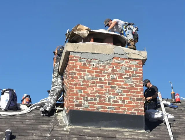 New Canaan Chimney Sweep installing a custom chimney crown in New Canaan, CT