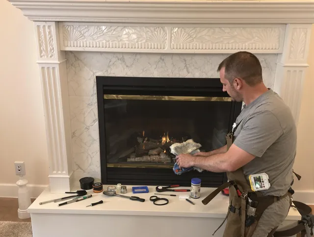 New Canaan Chimney Sweep performing fireplace maintenance in New Canaan, CT