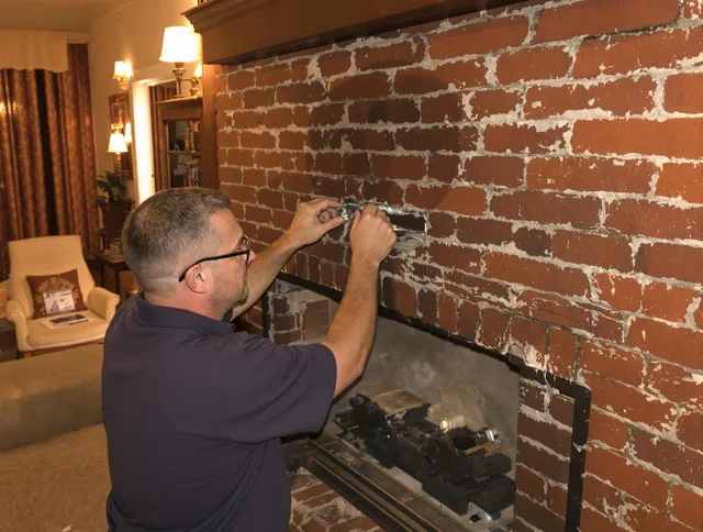 New Canaan Chimney Sweep expert fixing a fireplace in New Canaan, CT